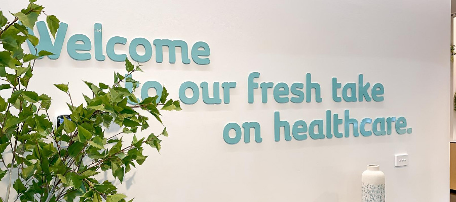 sign at the entrance of healthmint medical centre in croydon that says welcome to our fresh take on healthcare